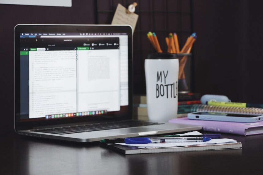 Laptop displaying an AI-generated lesson plan next to a teacher's handwritten edits