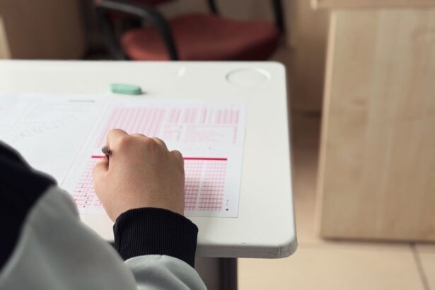Student practicing active recall on paper next to a laptop displaying an AI-generated quiz