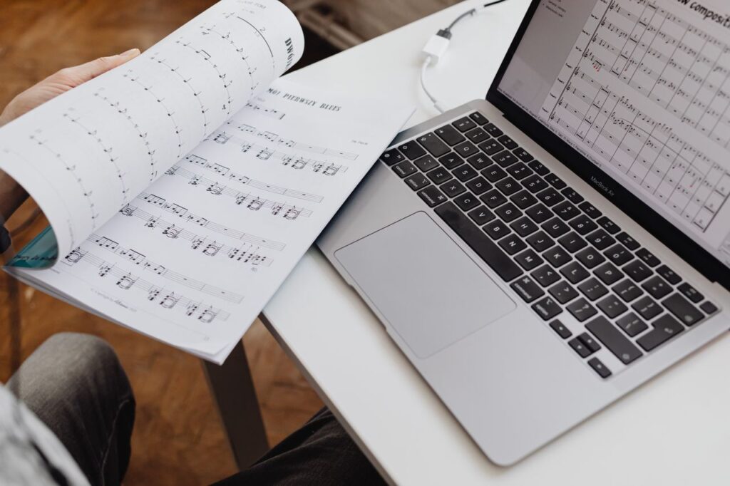 Laptop showing an AI-generated worksheet and answer key beside three differentiated printed versions
